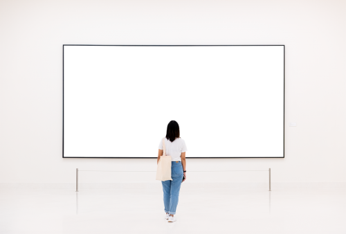 Woman looking at a frame mockup in an exhibition transparent png - 2024693