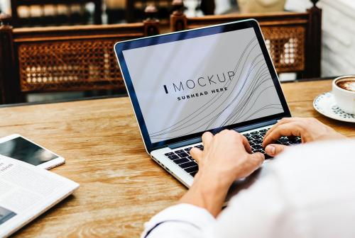 Businessman working on a laptop screen mockup - 502897