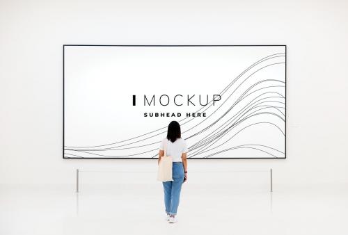 Woman at an exhibition looking at an art piece mockup - 502969