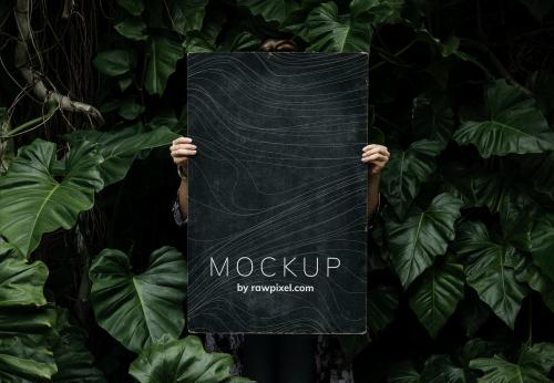 Female in a tropical background holding a signboard mockup - 502977