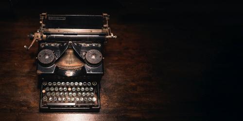 Old typewriter on a wooden table - 2044314