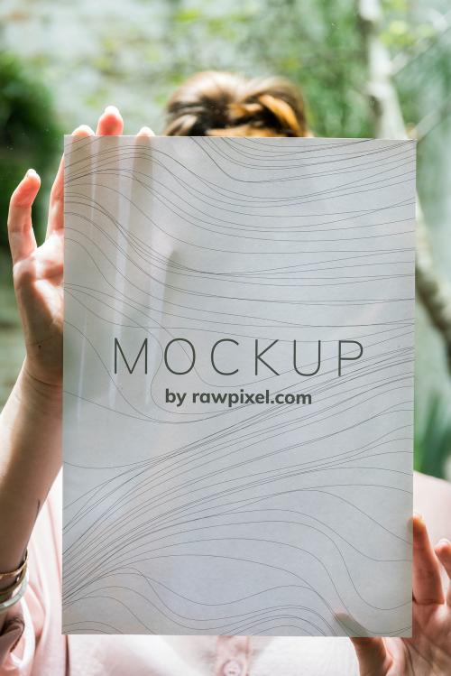 Woman showing a single sheet of mockup paper - 502984