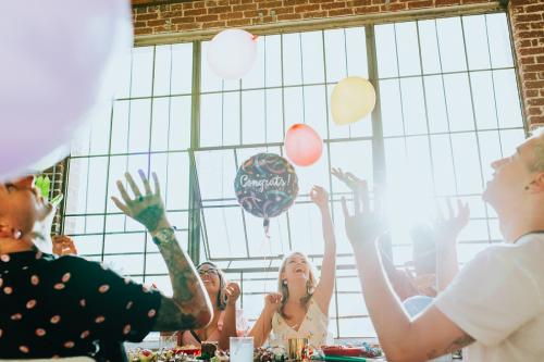 People playing with balloons at a party - 2097410