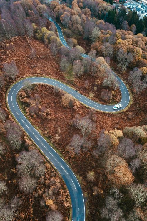 Drone shot of a curvy road in the Trossachs, Scotland - 2097921