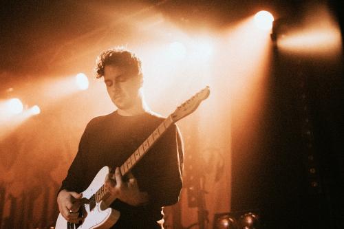 Guitarist playing an electric guitar in a concert - 2273421