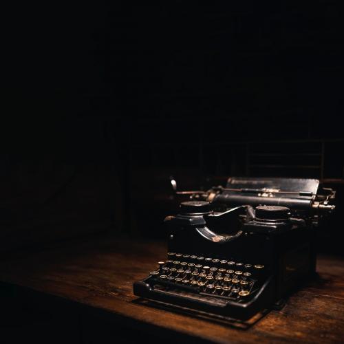 Old typewriter on a wooden table - 2044217