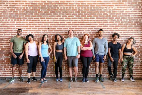 Group of sportive people by a brick wall - 2046937