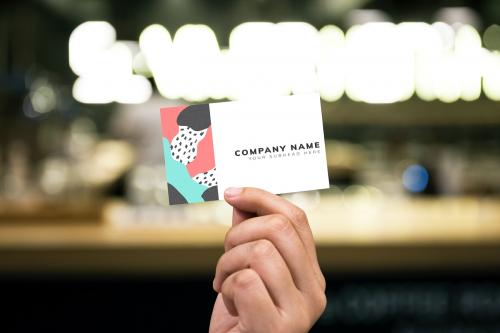 Holding up a business card mockup - 502685