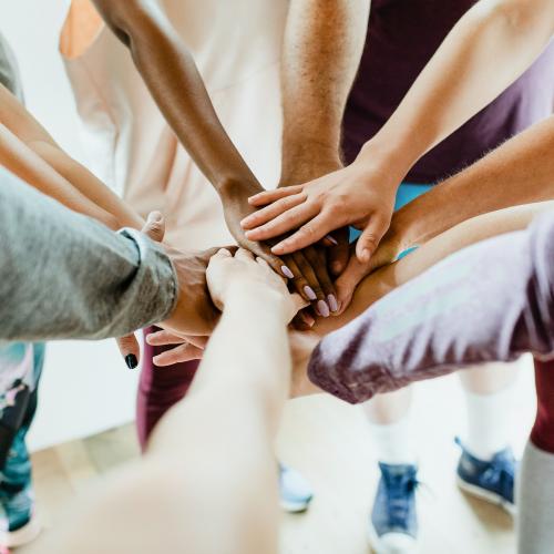 Group of diverse people stacking hands in the middle - 2194700