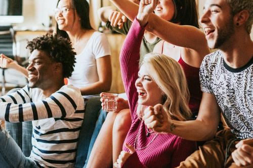 Friends watching a game show on the tv - 2203472