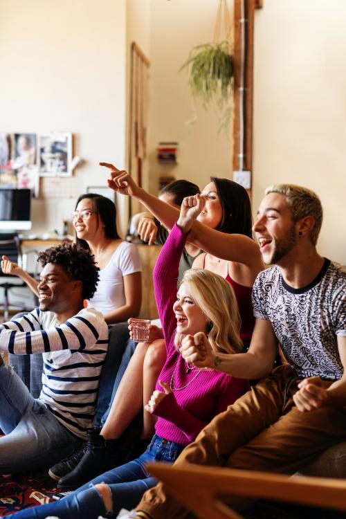 Friends watching a game show on the tv - 2204718