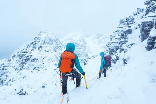 Mountaineers climbing a snowy Liathach Ridge in Scotland - 2221571