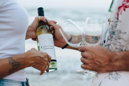 Couple enjoying a glass of wine by the beach - 502804