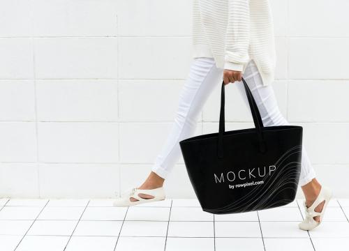 Woman holding a black tote bag mockup - 502814