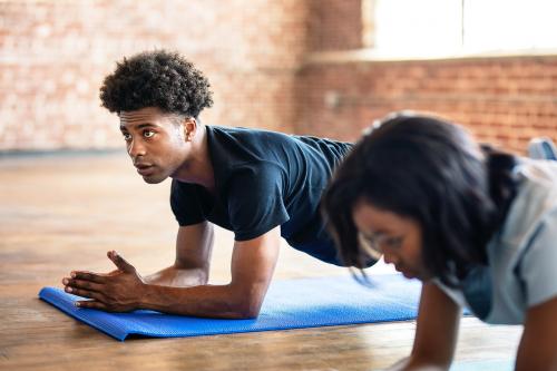 Group of sporty people practicing the elbow plank - 2041665