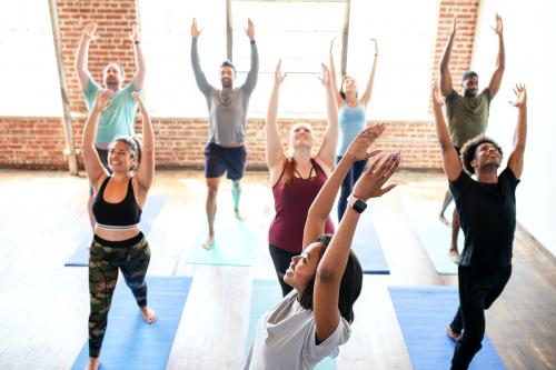 Trainer and her students in a Urdhva Hastasana pose - 2046930