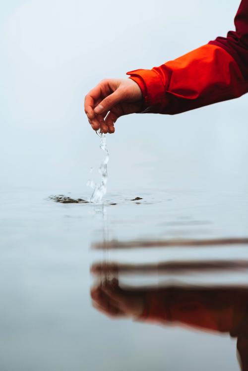 Hand reaching to the water below - 2097935