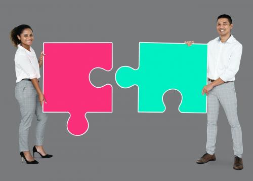 Colleagues connecting puzzle pieces - 493065