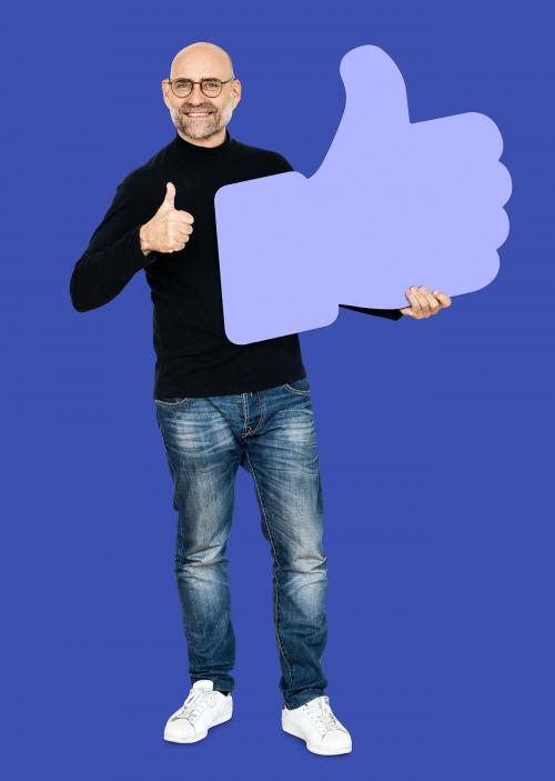 Cheerful man showing a thumbs up icon - 493286