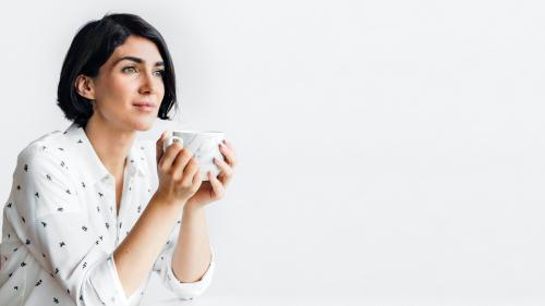 Woman sipping coffee at a cafe - 2033979