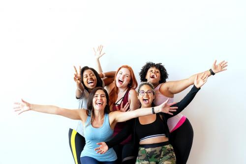 Group of happy sportive women with a white wall - 2046923