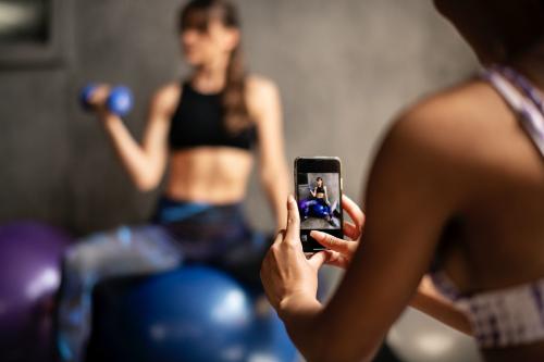 Sporty women taking a photo fro her friend - 2107475