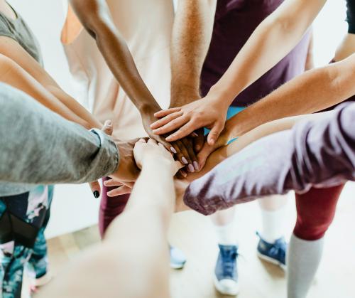 Group of diverse people stacking hands in the middle - 2194747