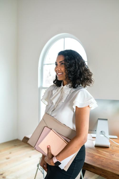 Black businesswoman carrying a digital device - 2204906