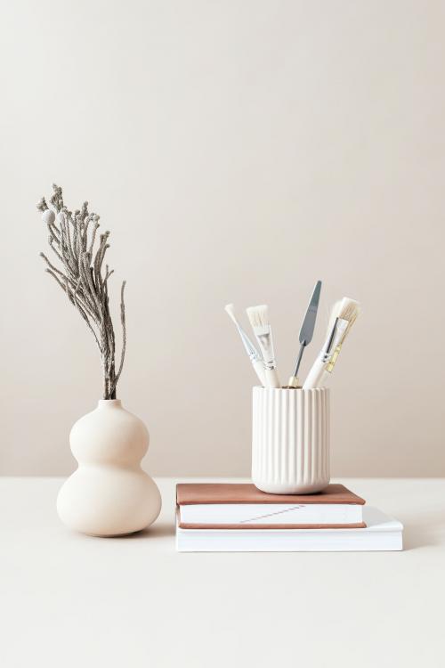 Minimal workspace with paint brushes and a vase - 2254305