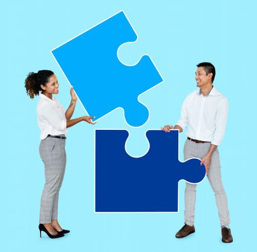 Colleagues connecting puzzle pieces - 492589