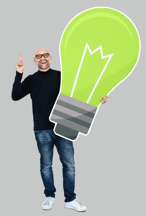 Happy man holding a light bulb icon - 492598