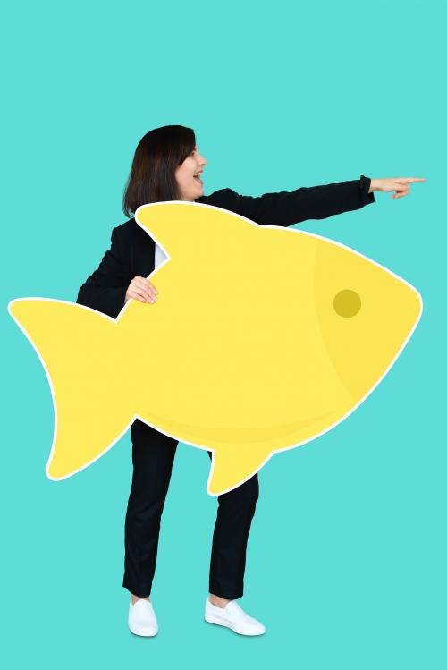 Businesswoman holding a big fish - 492631