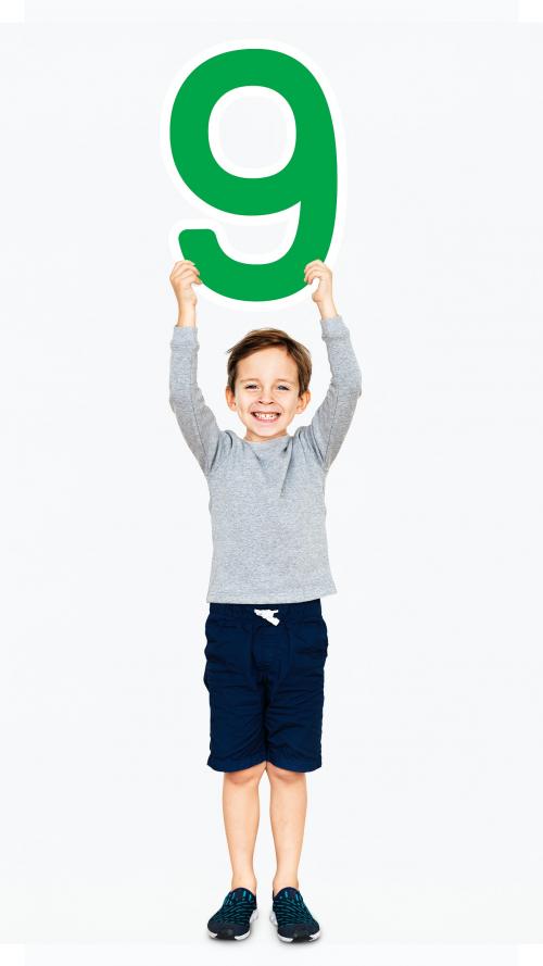 Cheerful boy holding number nine - 491810