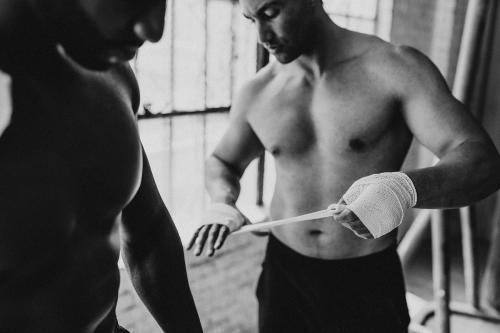 Male boxer putting a strap on his hand - 2107359