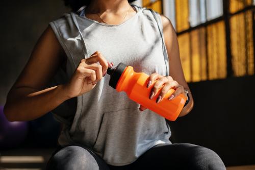 Woman drinking water after workout - 2109029