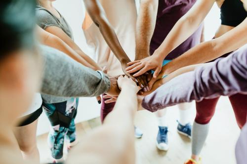 Group of diverse people stacking hands in the middle - 2194740