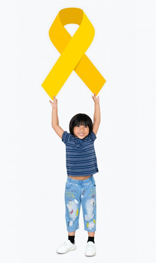 Young boy holding gold ribbon supporting childhood cancer awareness - 491936