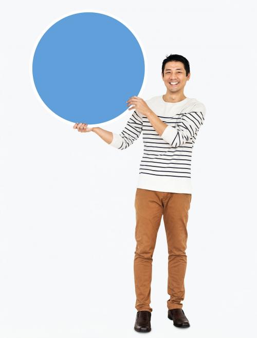 Cheerful man holding a blank blue circle - 490950