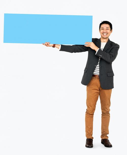 Cheerful man showing a blank blue banner - 491000