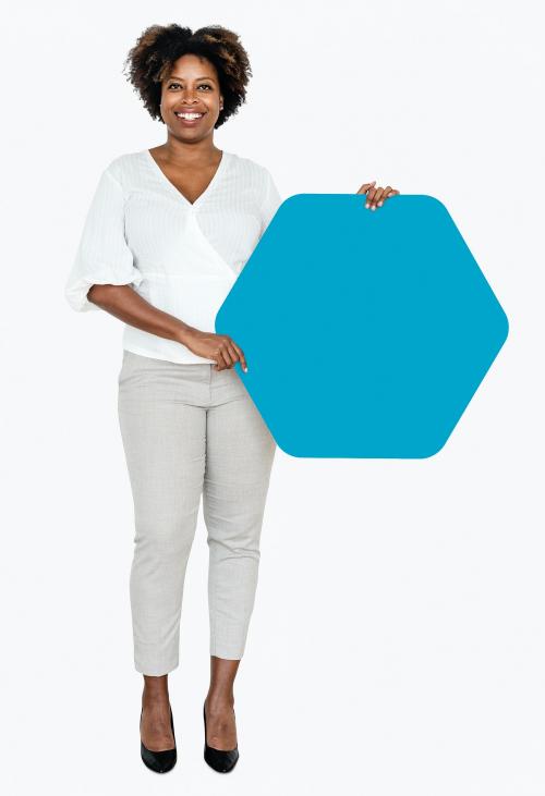 Cheerful woman showing a blank blue hexagon shaped board - 491011