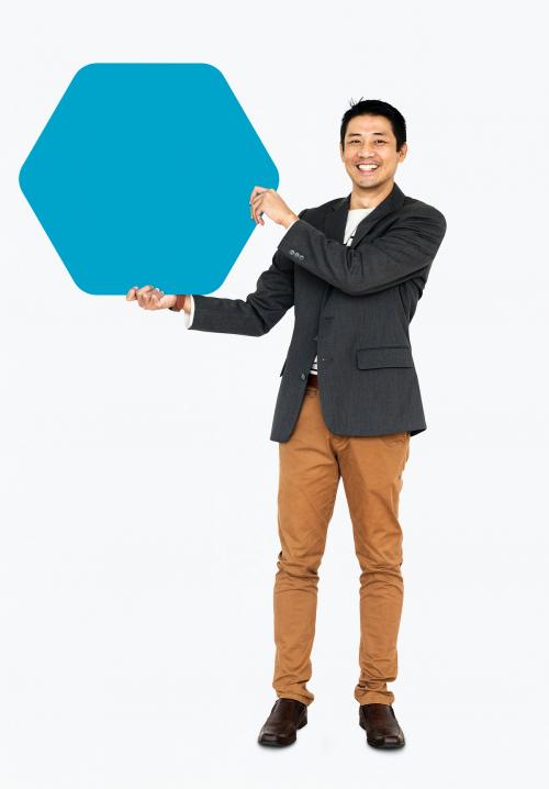 Cheerful man showing a blank blue hexagon shaped board - 491020