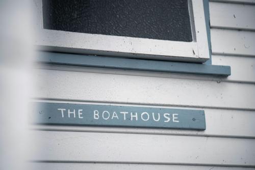 Closeup of wooden boathouse sign - 2041457