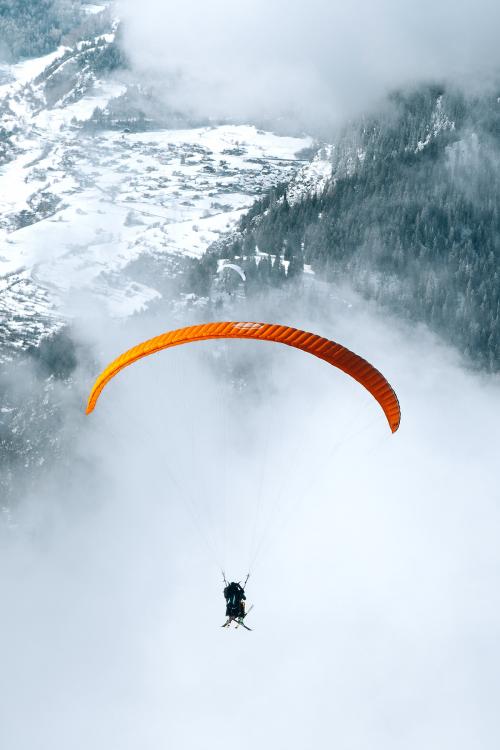 Paragliding on a cloudy day through the mountain - 2255106