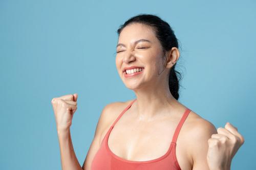 Happy woman in sportswear on blue background - 2255283