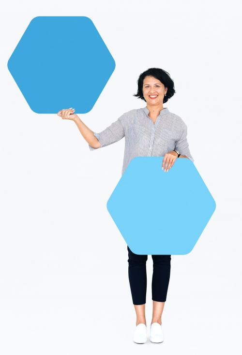 Cheerful woman showing blue hexagon shaped boards - 491165