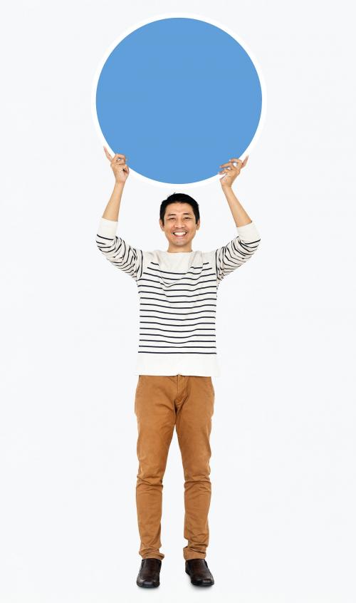 Cheerful man holding a blank blue circle - 491175