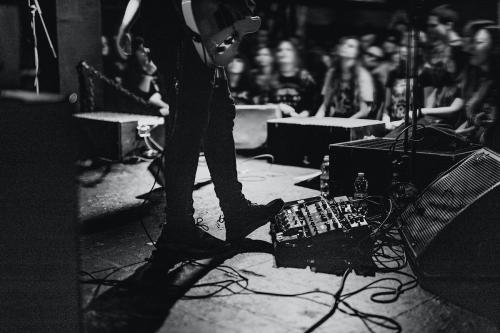 Musician using a pedal board in a concert - 2273450