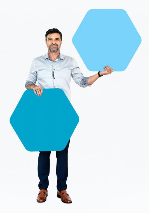 Cheerful man showing blue hexagon shaped boards - 491270