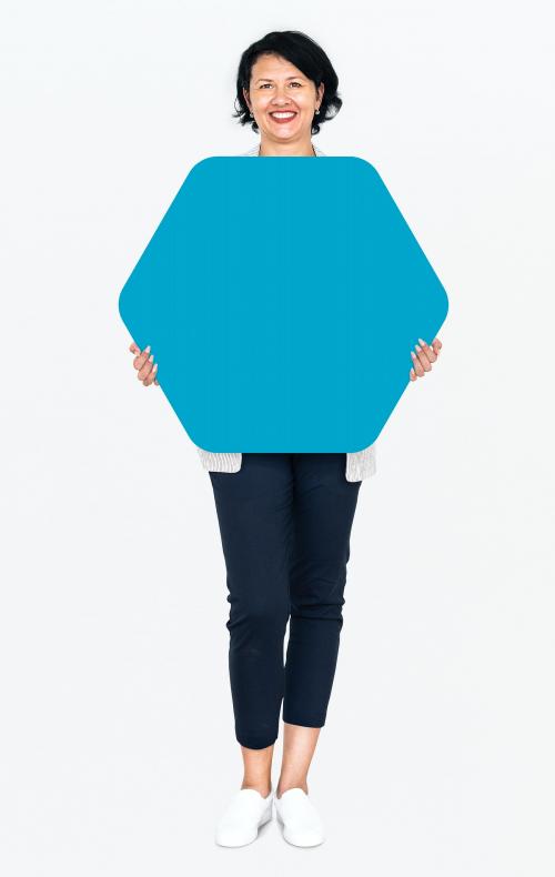 Cheerful woman showing a blank blue hexagon shaped board - 491277