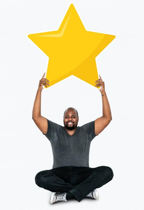 Cheerful man holding a golden star rating symbol - 477586